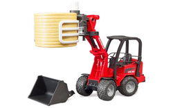 Image of Schaeffer Compact loader 2630 with bale gripper and 1 round bale